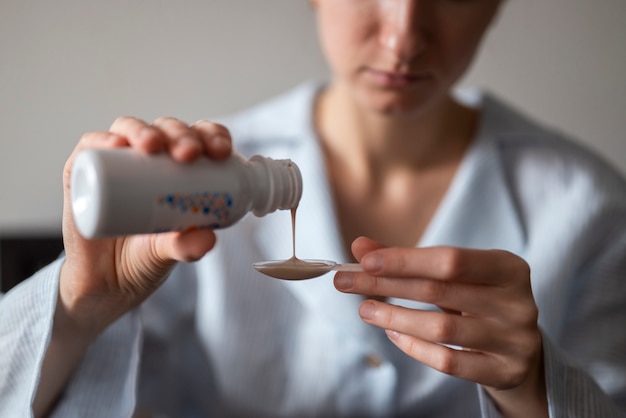 Close up woman pouring syrup