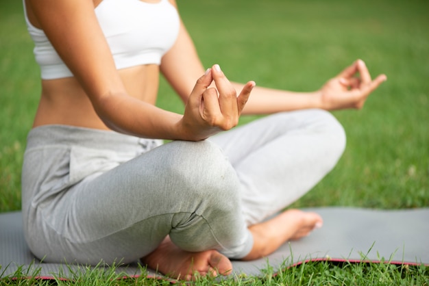 Close-up woman practicing meditation outdoors