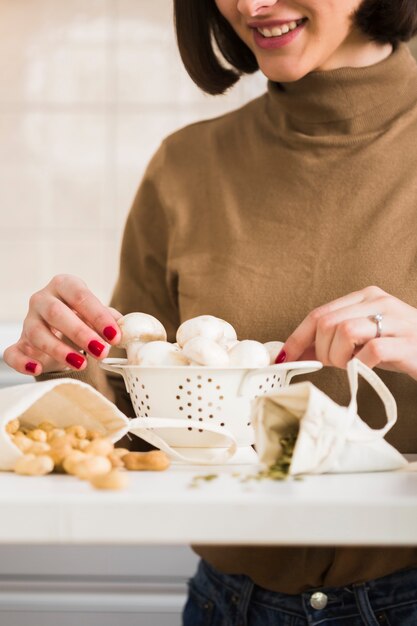 Close-up woman preparing homemade mushrooms