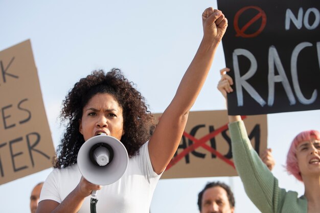 Close up woman protesting with megaphone