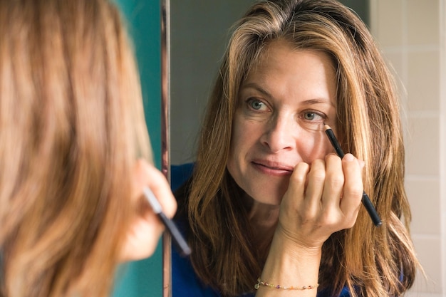 Close up woman putting on make-up