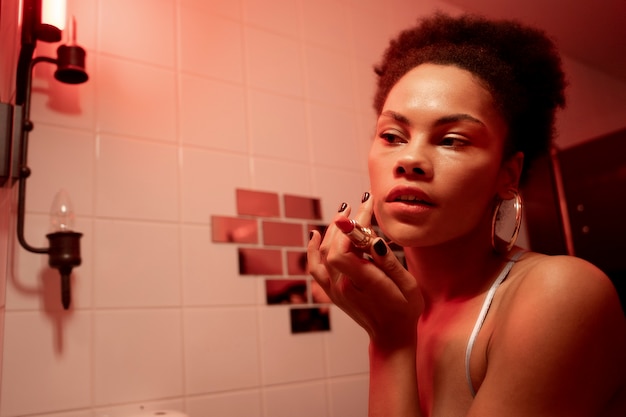 Close up woman putting on makeup