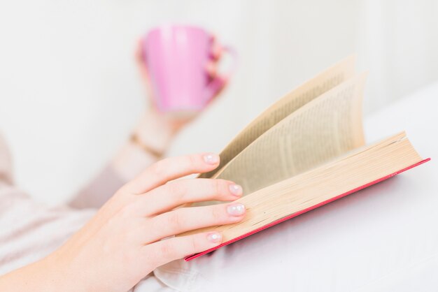 Close-up of woman reading book