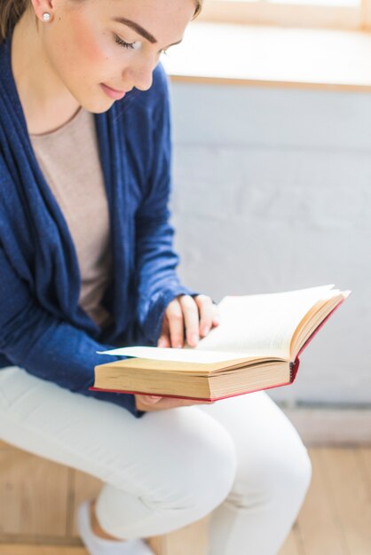 Close-up of a woman reading book