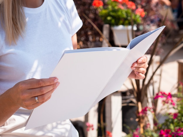 Close-up woman reading a mock-up magazine