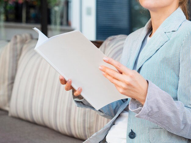 Close-up woman reading a mock-up magazine