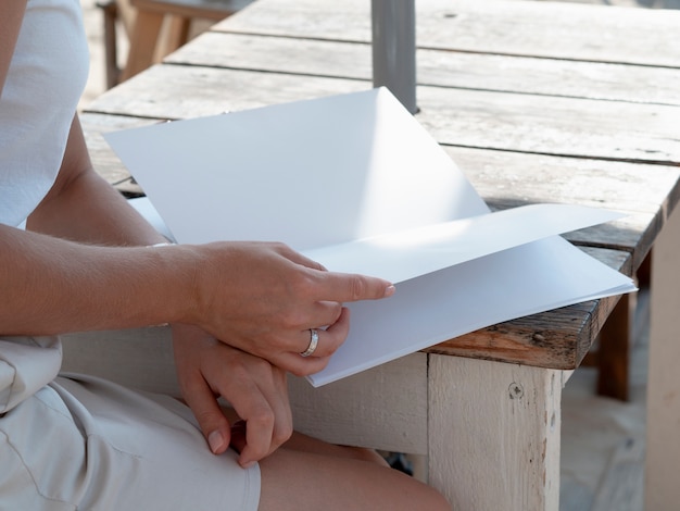 Free photo close-up woman reading a mock-up magazine