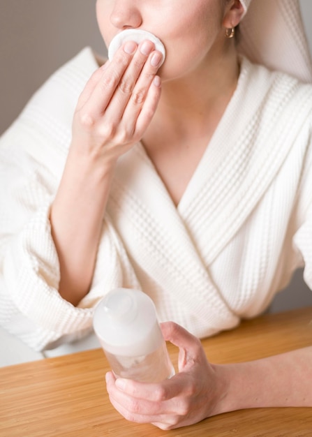 Free photo close-up woman removing make up