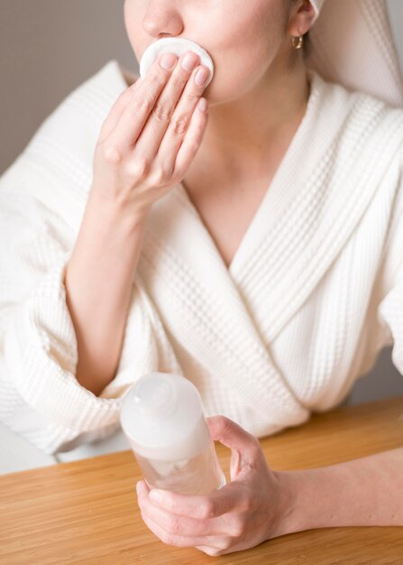 Close-up woman removing make up