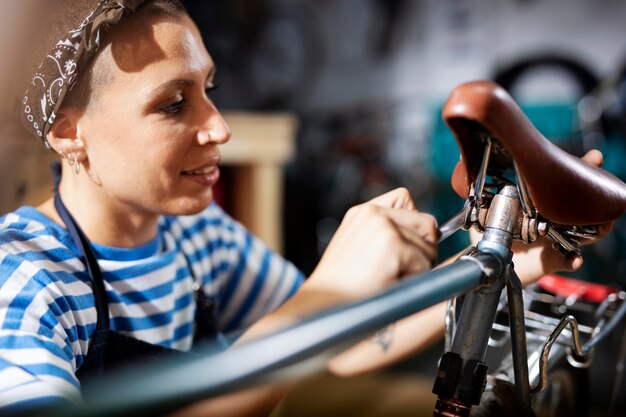 close up woman repairing bicycle