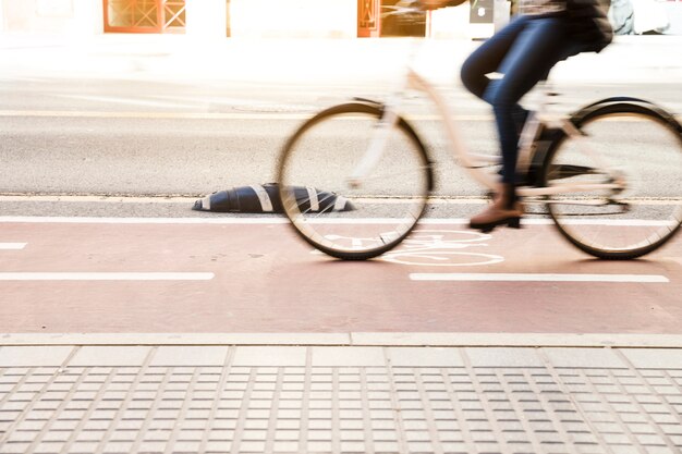 Close up of a woman riding bike in cycle lane