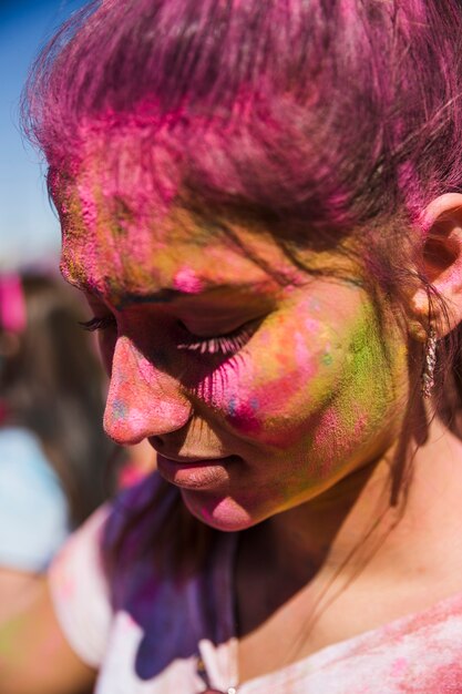 Close-up of a woman's face covered with holi color