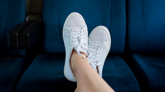 Close-up woman's feet on train seat