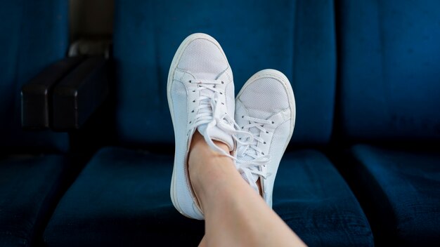 Close-up woman's feet on train seat