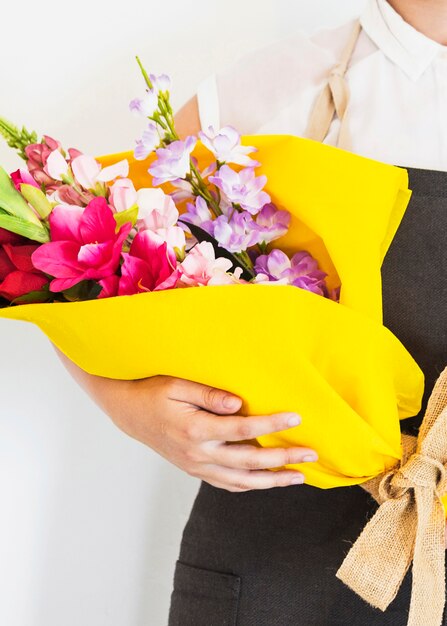 Close-up of a woman's hand holding bouquet of fresh flowers