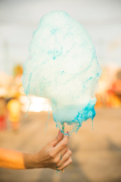 Close-up of a woman's hand holding candy floss