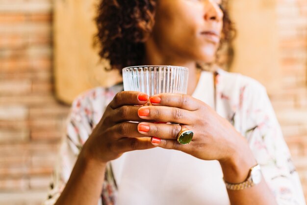 Close-up of woman's hand holding glass in hand