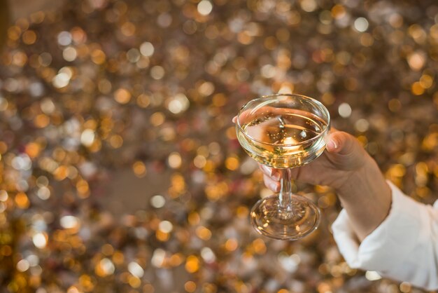 Close-up of a woman's hand holding glass of whiskey