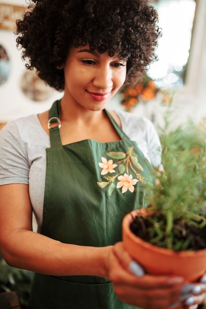 Free photo close-up of a woman's hand holding potted plant