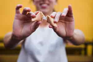 Free photo close-up of woman's hand showing message in fortune cookie