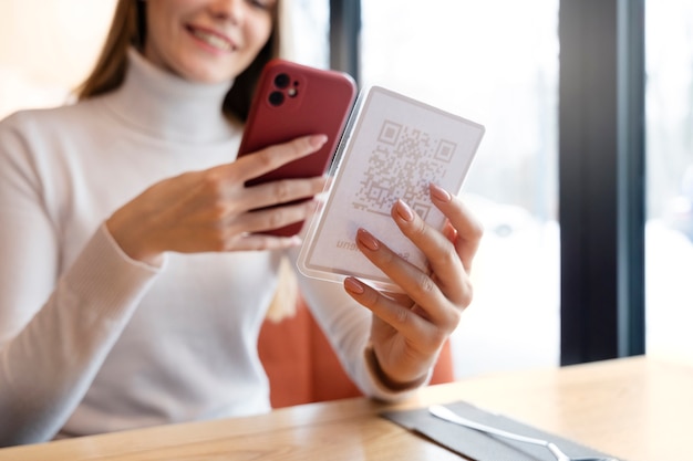 Close up woman scanning qr with phone