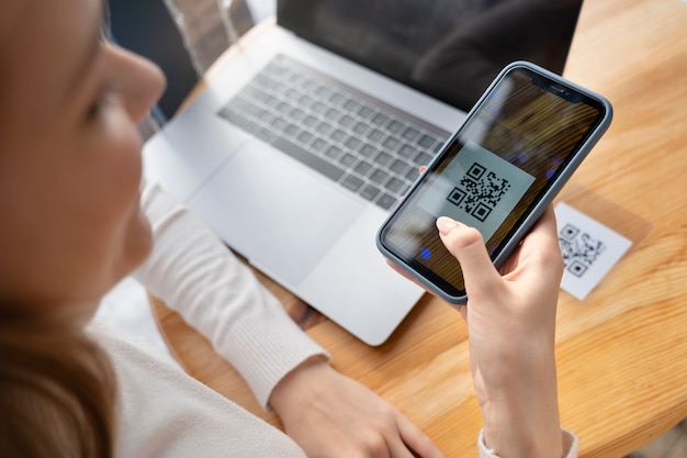 close up woman scanning qr