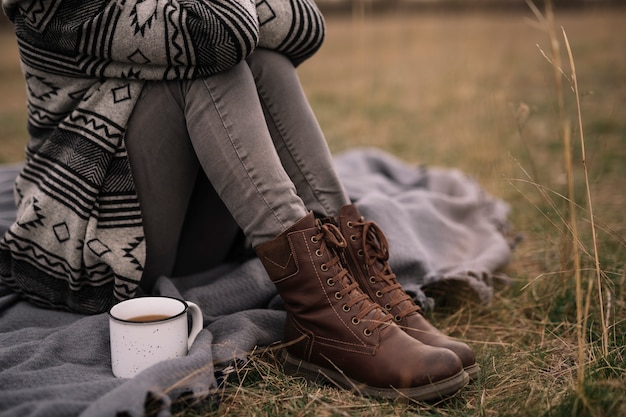 Free Photo close-up woman sitting on blanket