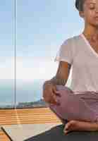 Free photo close up woman sitting on yoga mat