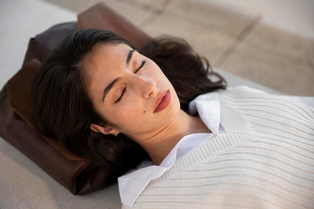 Close up woman sleeping on bag