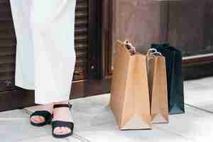 Free photo close-up woman standing near shopping bags