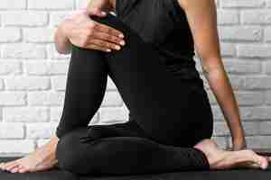 Free photo close-up woman stretching on mat