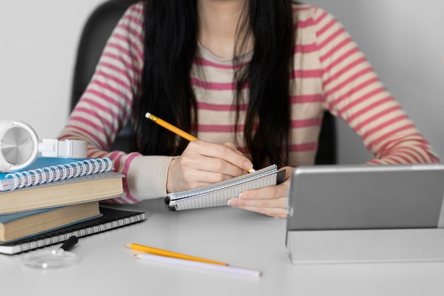 Free photo close up woman taking notes