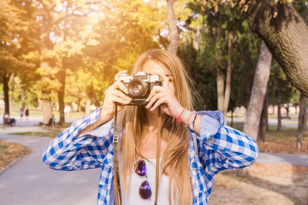 Close-up of a woman taking photo on camera