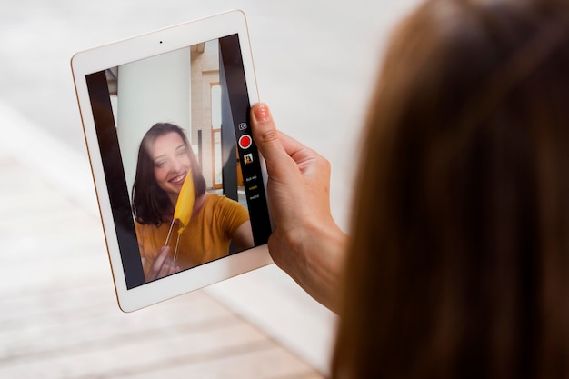 Close-up woman taking selfie with mask