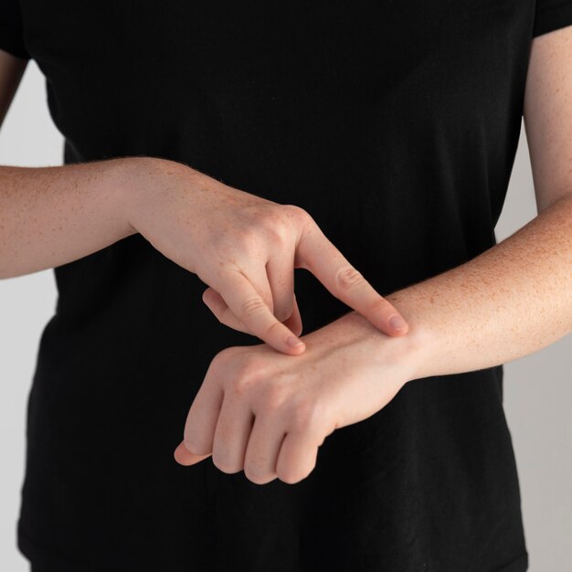 Close-up woman teaching sign language