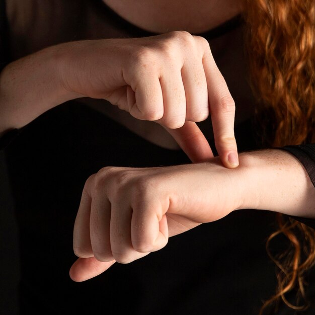 Close-up woman teaching sign language