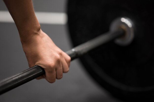 Close-up woman training with weightlifting