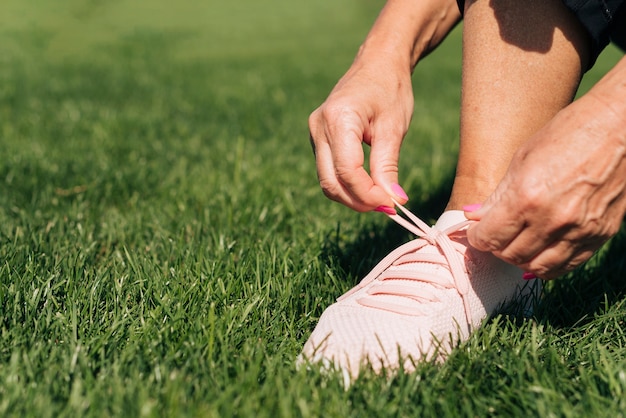 Close-up woman tying her shoe laces