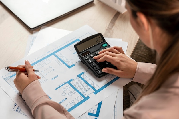 Close-up woman using calculator