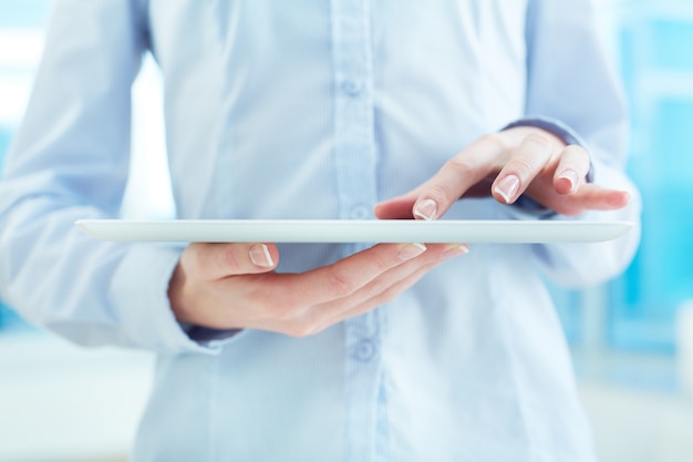 Close-up of a woman using digital tablet