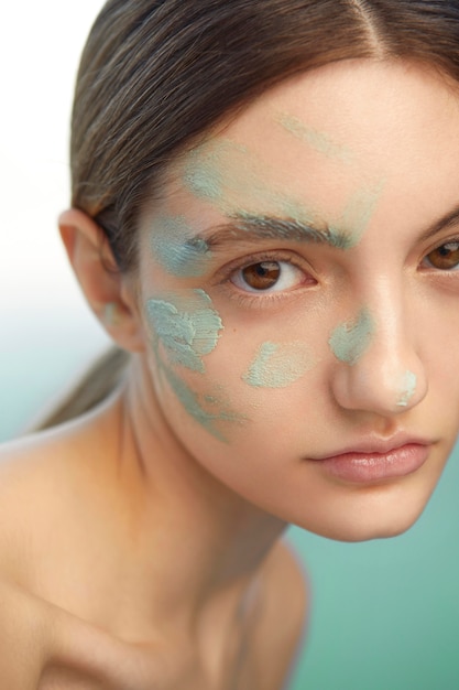 Close up woman using facial mask