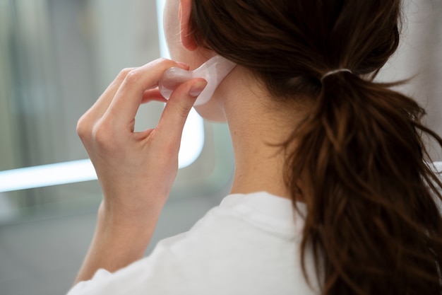 Close up woman using gua sha tool