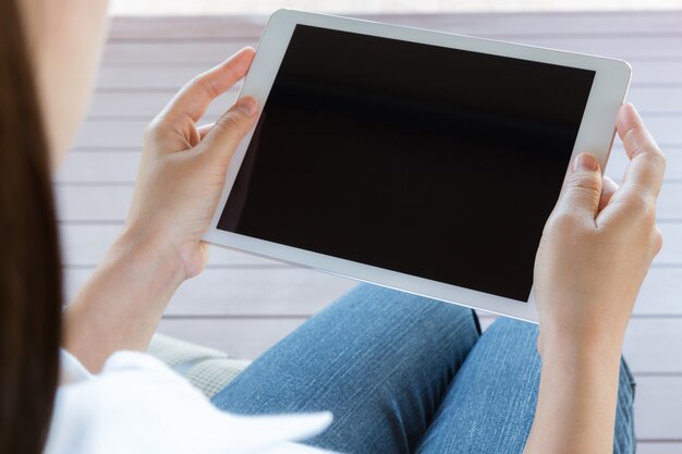 Close-up of woman using her digital tablet