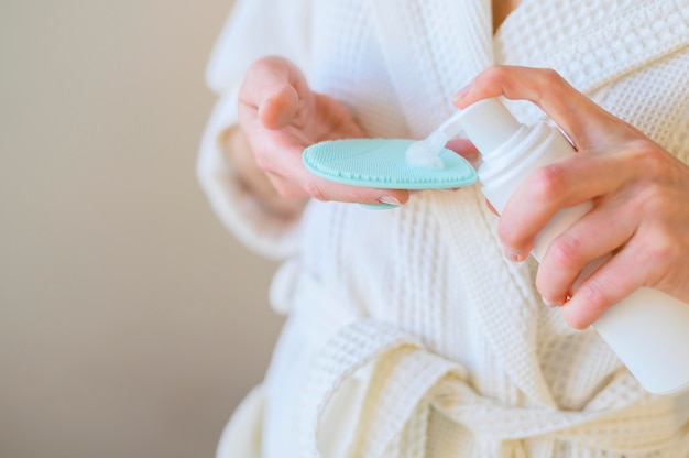 Close-up of woman using lotion