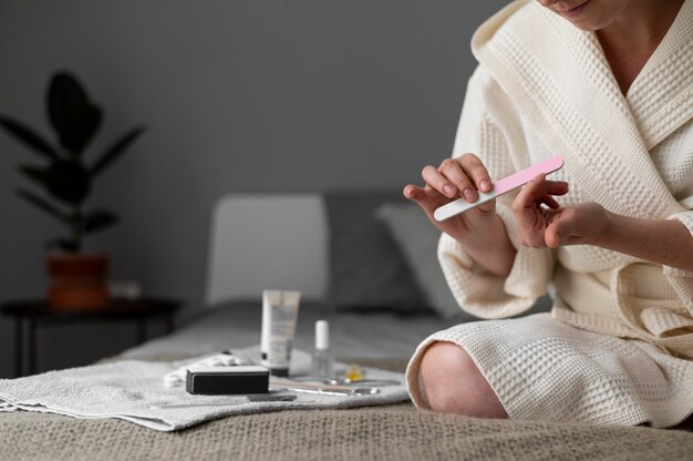 Close up woman using nail file