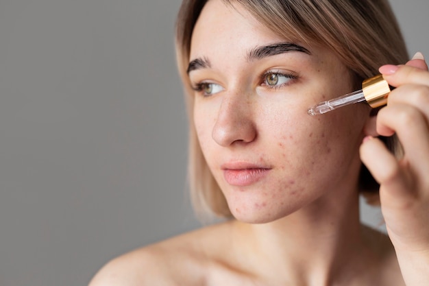 Close up woman using serum