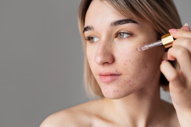 Close up woman using serum