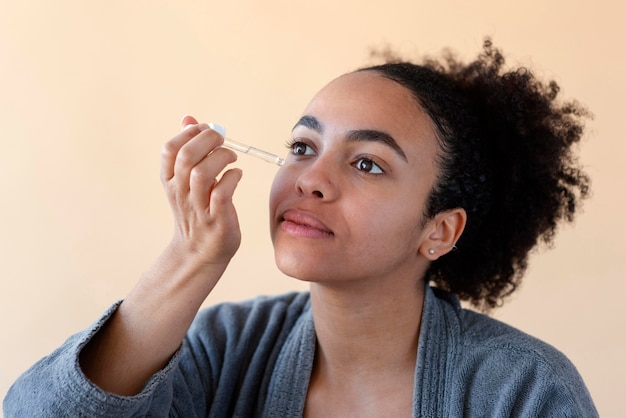 Close up woman using serum