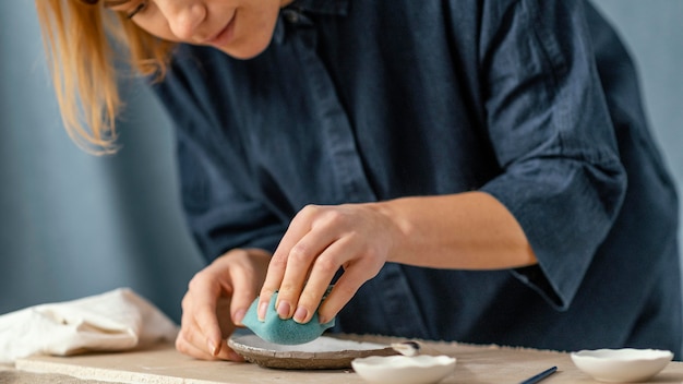 Close-up woman using sponge