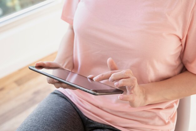 Close-up woman using tablet